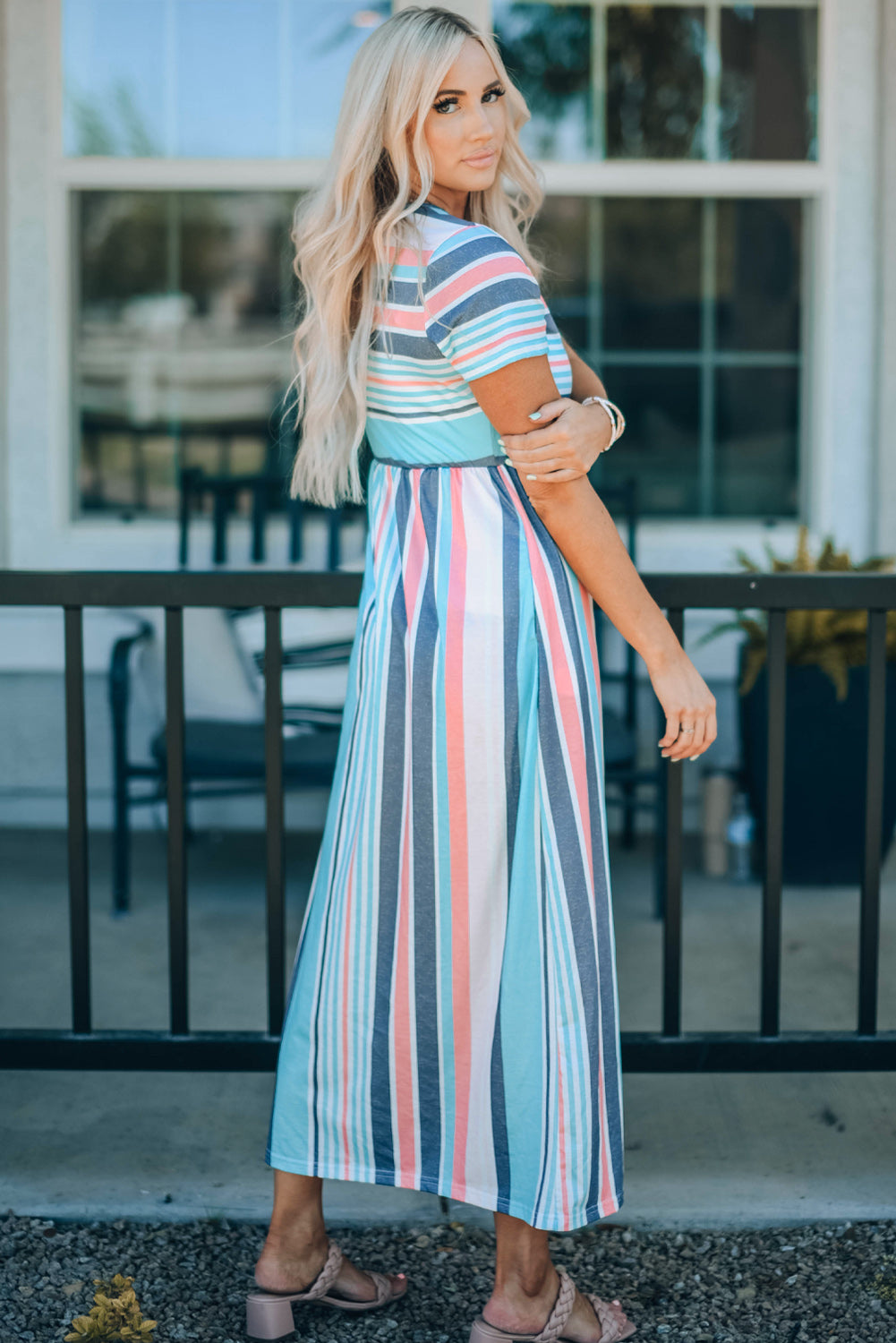 Woman wearing a striped high waist short sleeve maxi dress.