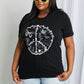 Woman modeling graphic print black tee with graphic tee with white ink - Peace sign with flowers and butterflies.