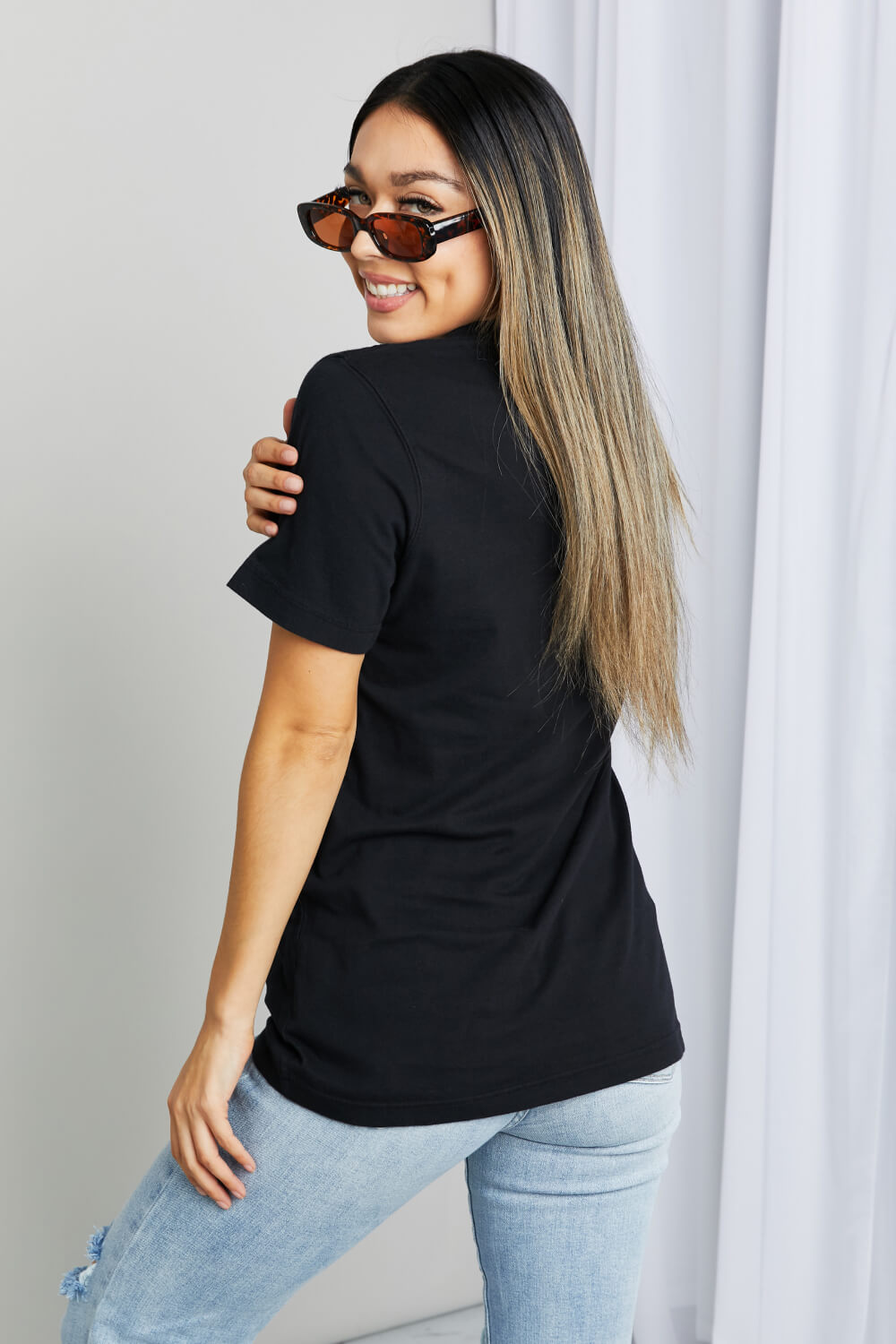 Woman modeling black tee with graphic print with white ink print - "Desert Dreamer"