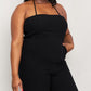 Woman modeling black halter neck wide leg jumpsuit.
