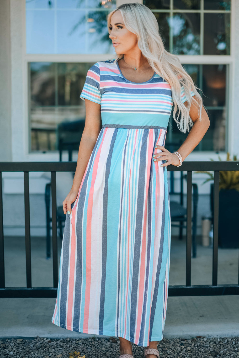 Woman wearing a striped high waist short sleeve maxi dress.